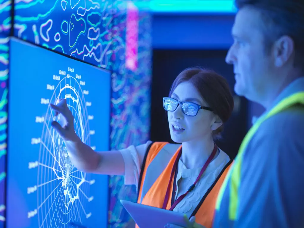 A woman and man examining data on a screen