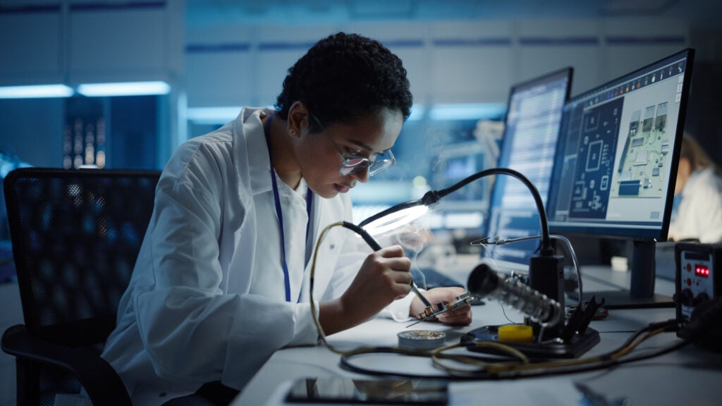 A woman working on a piece of technology