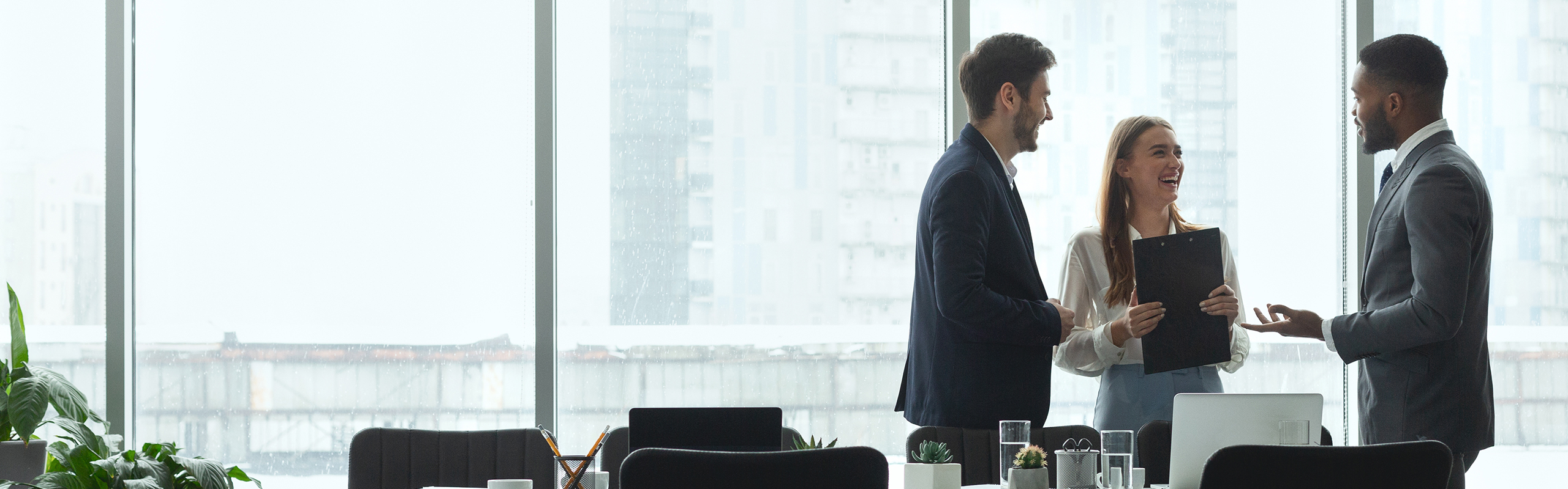 three business people talking in a meeting room