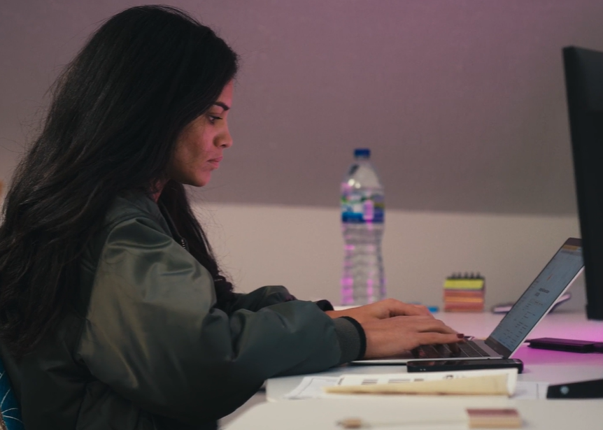 A woman using a laptop.