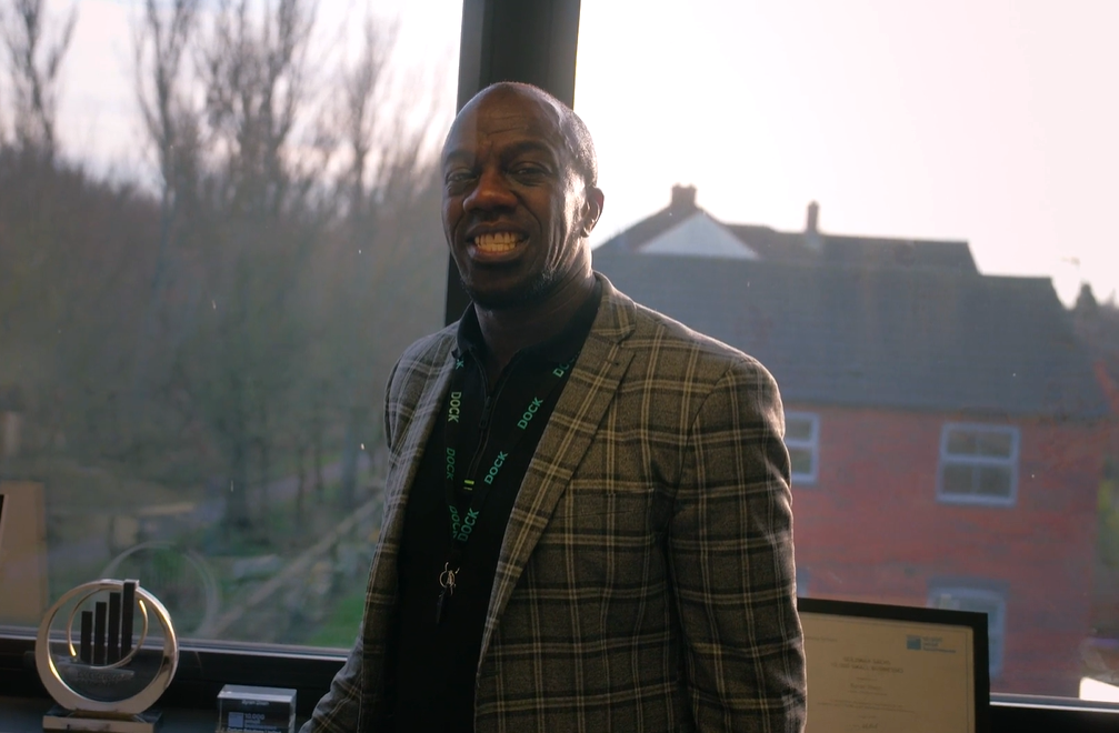 A man in business attire smiling at the camera.